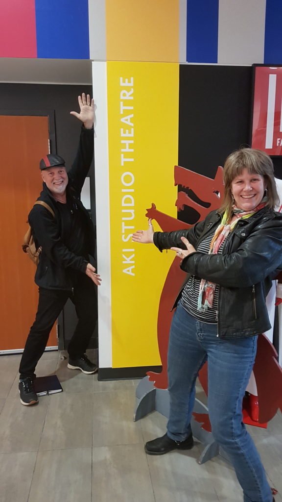 Lorene and Doug in front of the Aki Studio sign